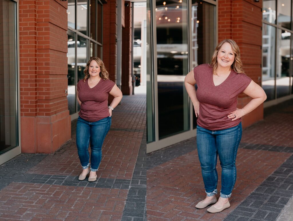 Val standing confidently in front of an urban wall in a capsule outfit