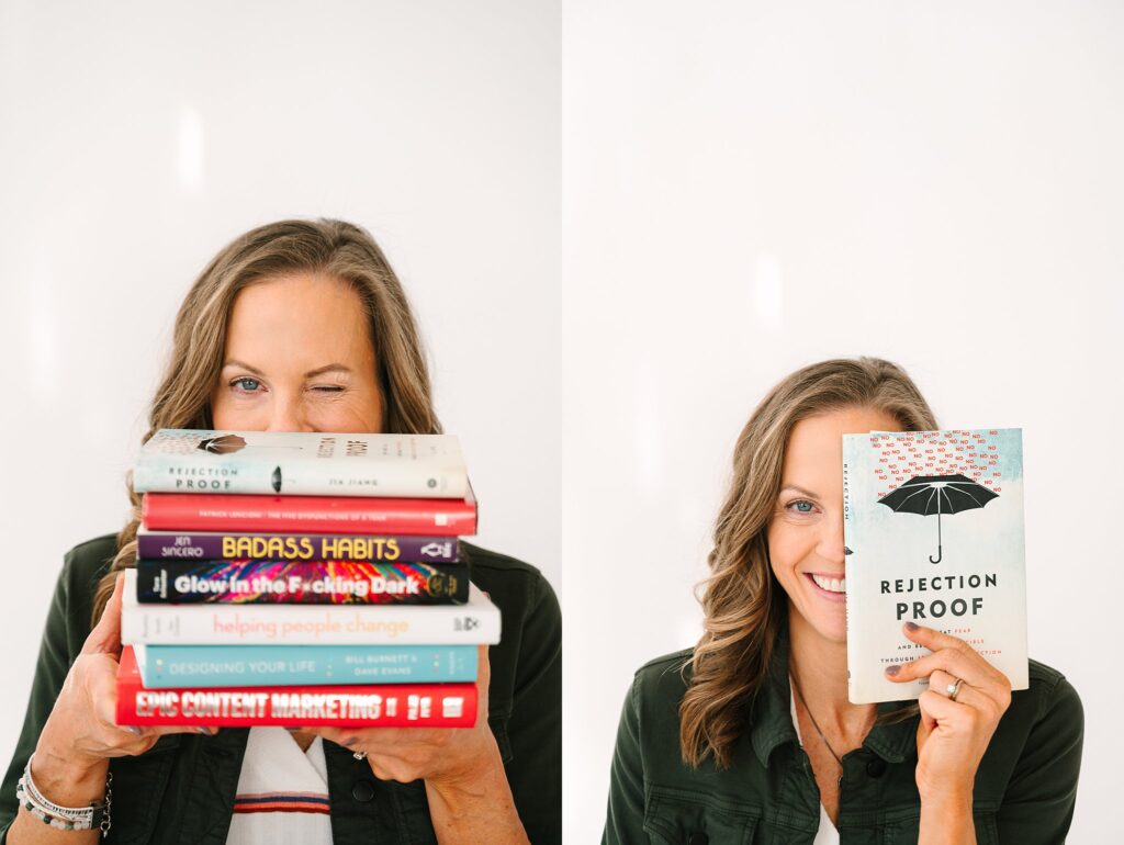 Lydia with stack of business books for coaching brand photos
